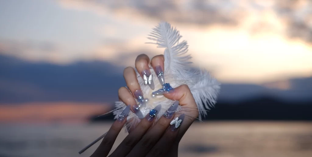 A beautiful nail set, photo taken at the sea with in the background the sunset