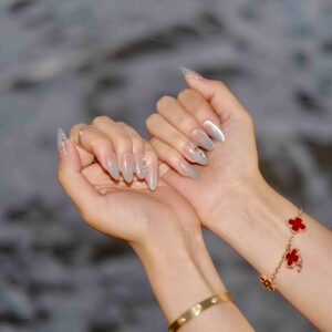 A close up of a hand wearing Serene Healer Medium Press On Nails, handmade by Fasunidy